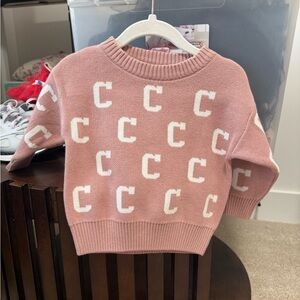 Pink Sweater with White Lettering